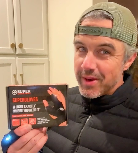 Customer holding SuperGloves product box
