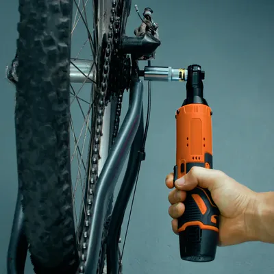The SuperRatchet held upright with its socket on a mountain bike's rear axle nut