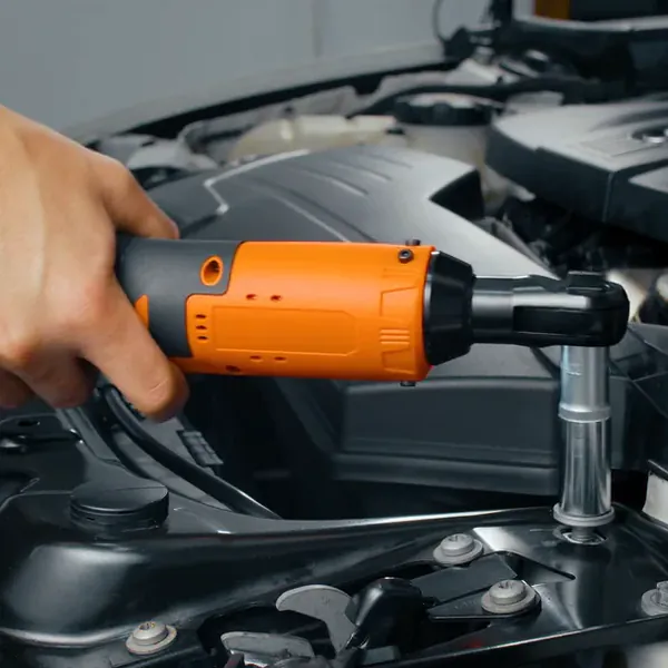 A hand runs the SuperRatchet on an extension and socket seated on a bolt in a car's engine bay